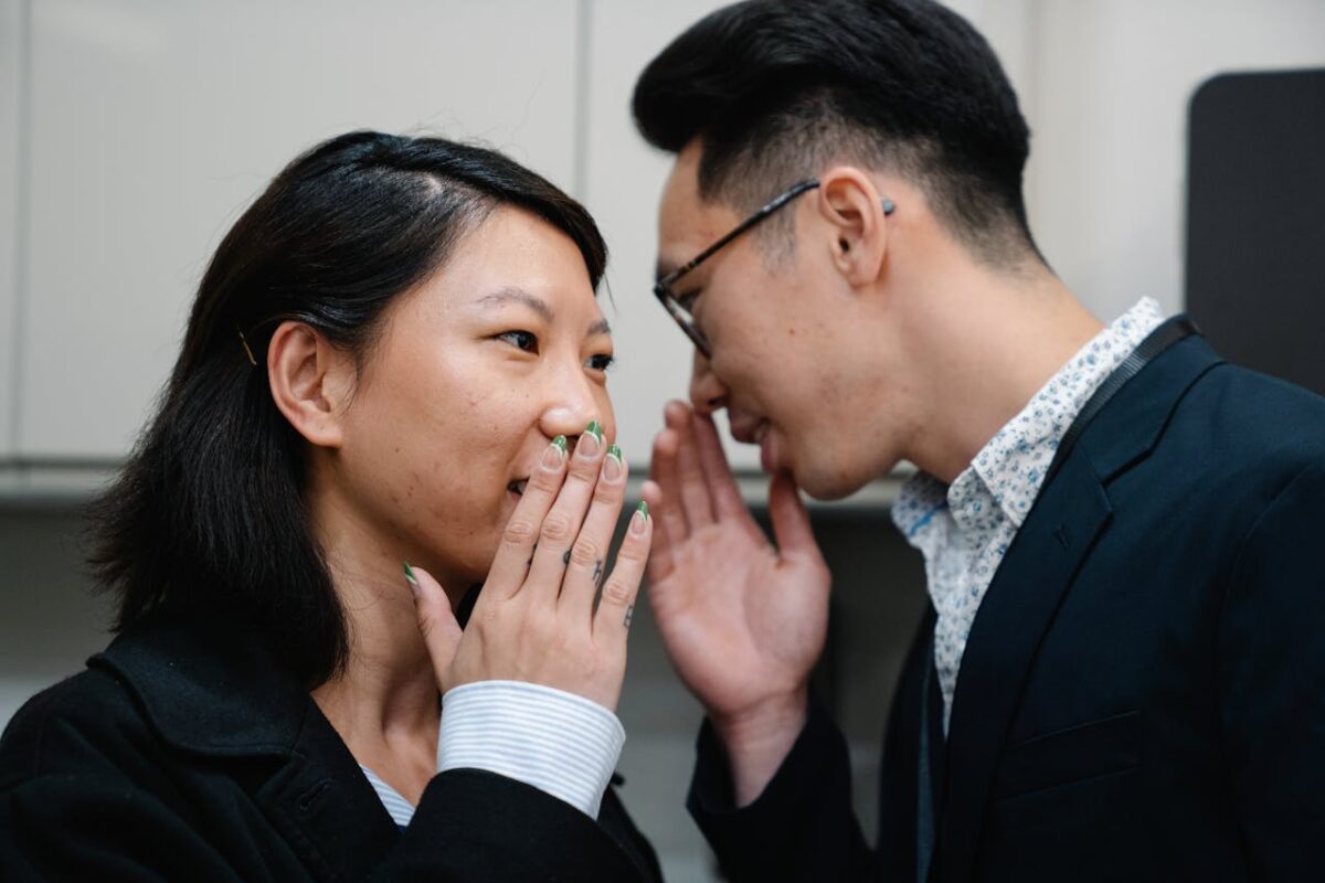 photo-of-a-man-telling-a-secret-to-a-woman