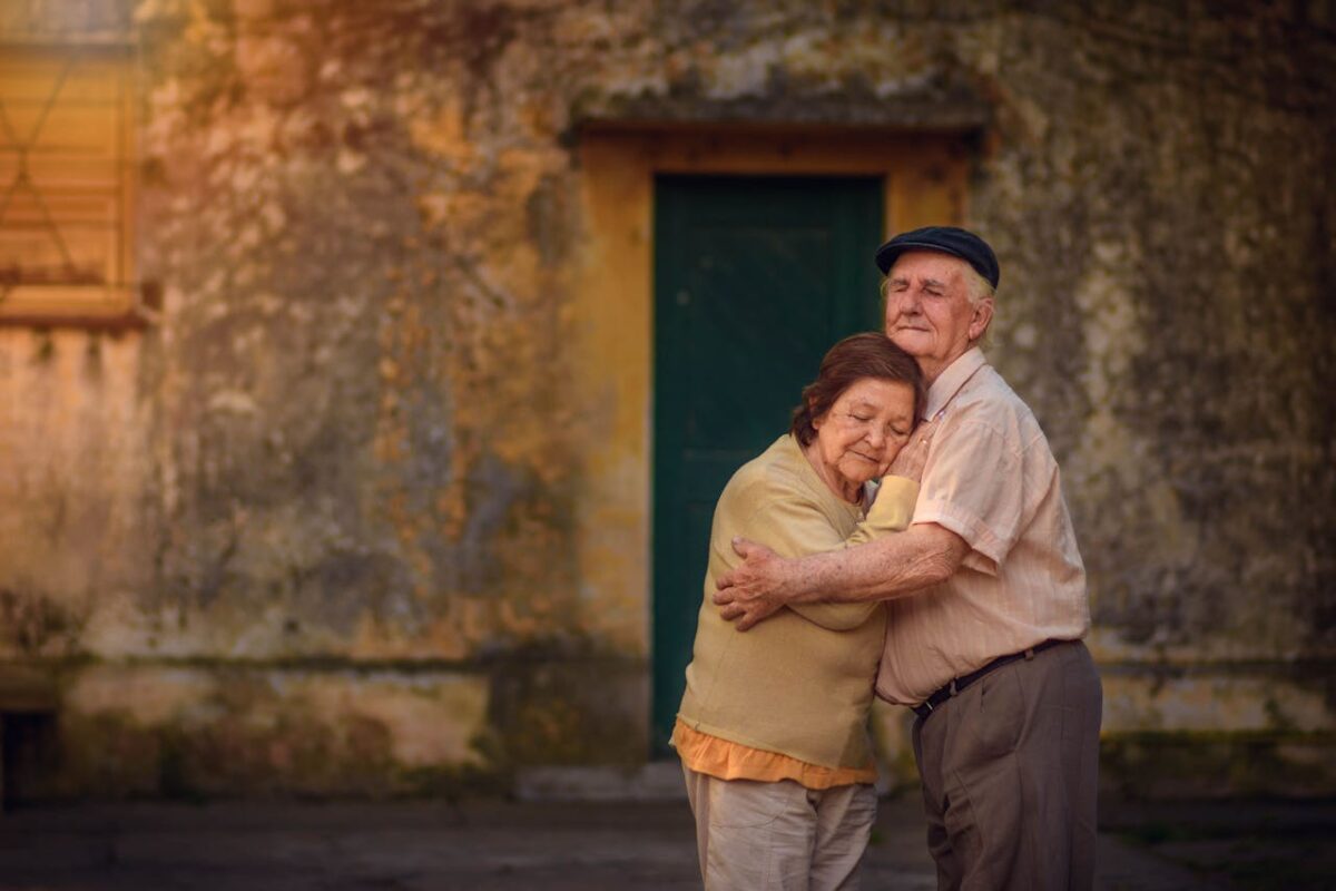 8 Reasons Calling 69 “Officially Old” Gets Aging Wrong 4 elderly-couple-sharing-a-heartfelt-hug-outdoors-
