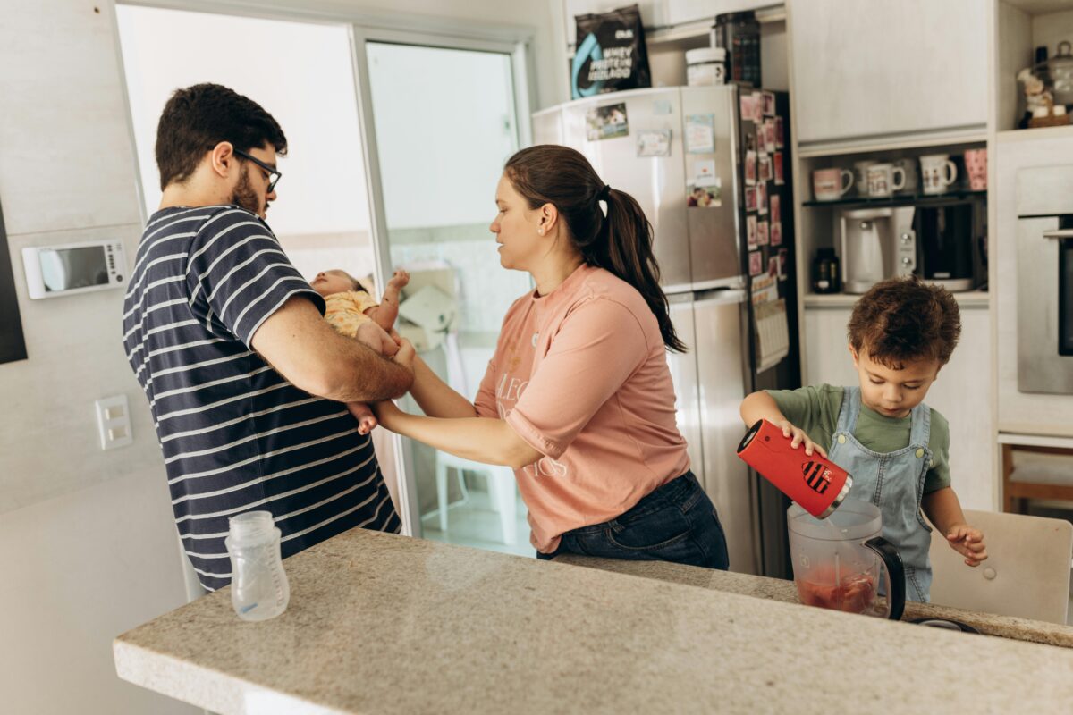 8 Childhood Money Habits That Are Suppressing Your Finances Today 3 couple-with-son-and-baby-in-kitchen
