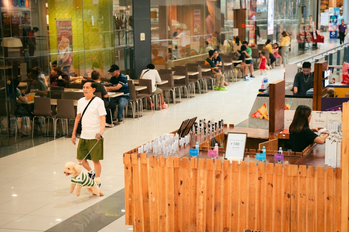 a-woman-walking-her-dog-in-a-mall-