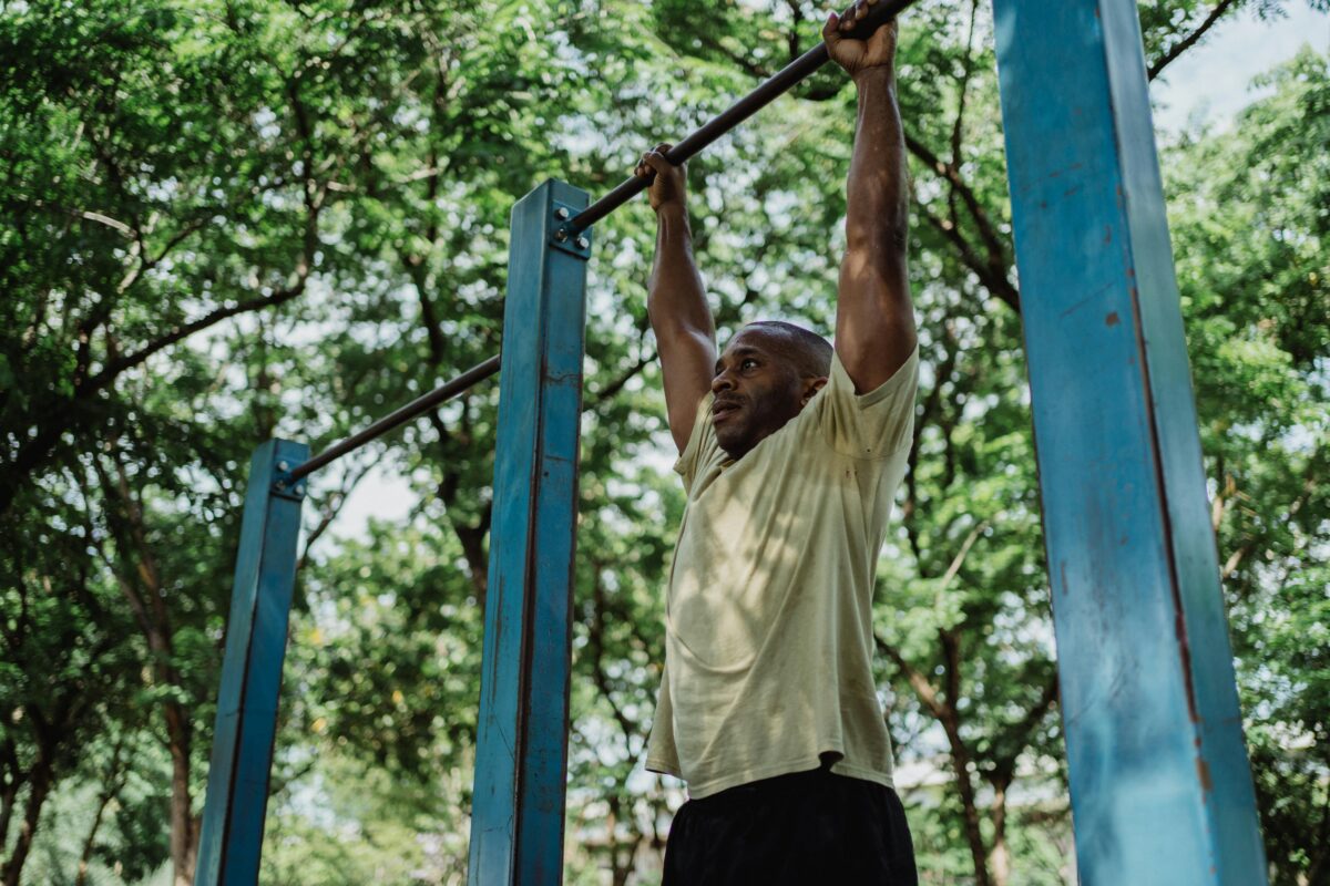 a-man-hanging-on-a-pull-up-bar