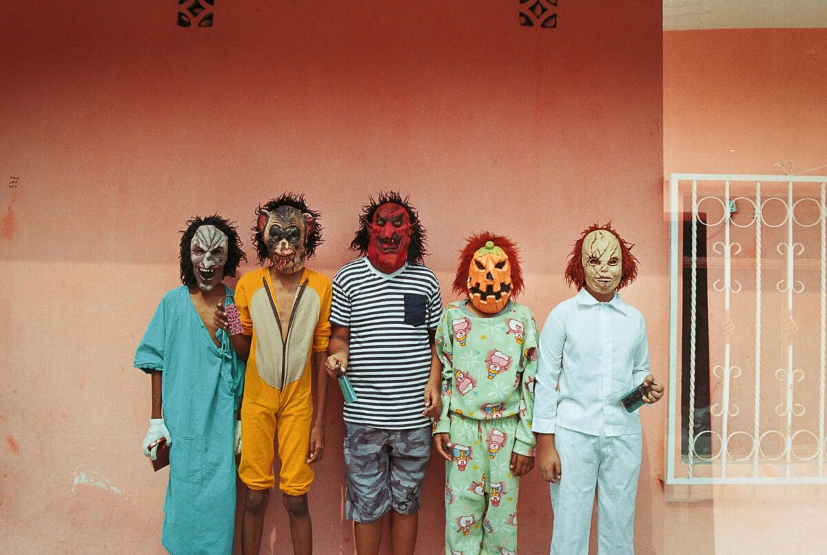 8 Creepy Ways Clothing Helps Cults Control People 5 group-of-children-in-masks-and-costumes-posing-near-house-wall
