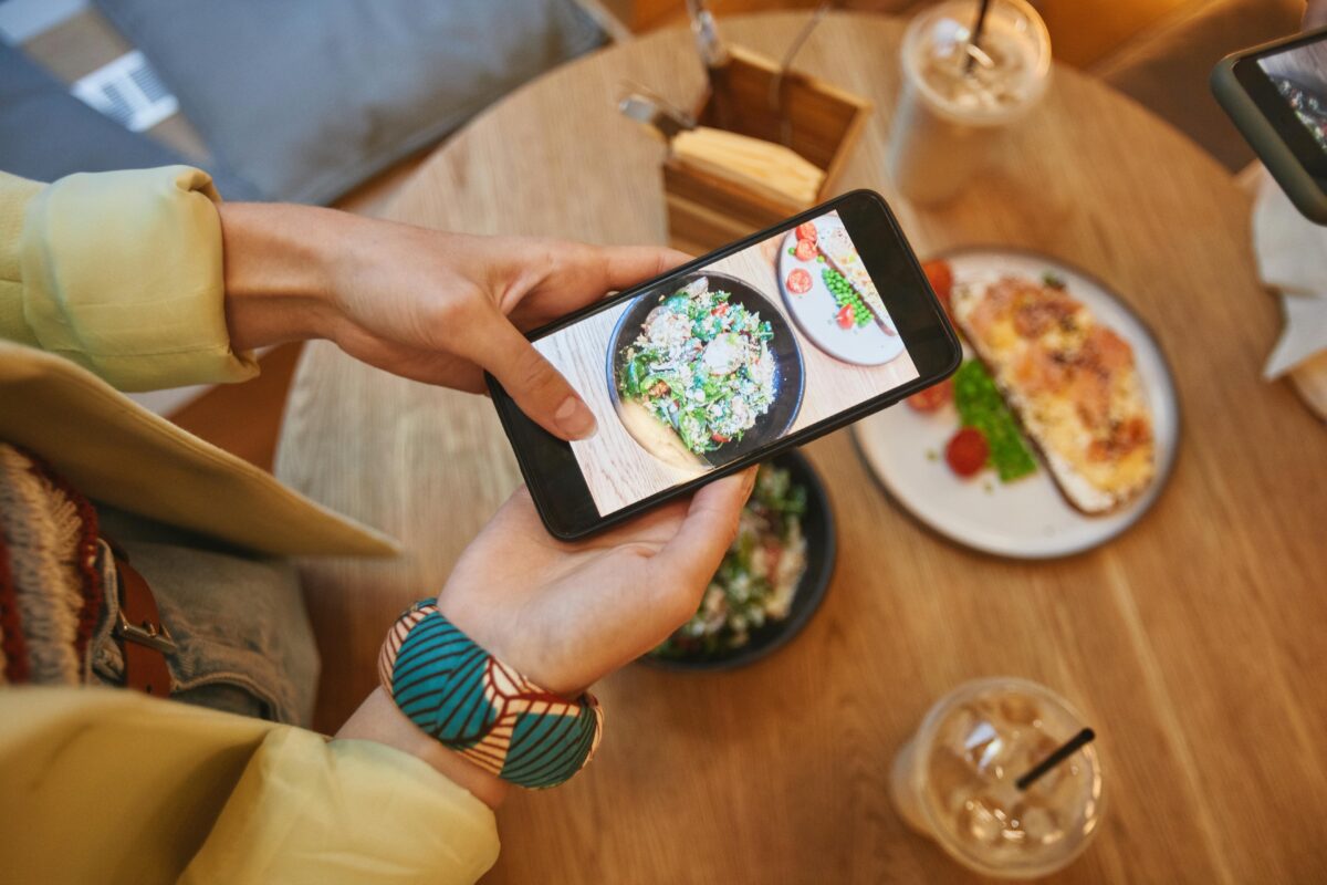 7 Ugly Truths Food Delivery Apps They Don’t Put on the Receipt 3 a-person-taking-a-picture-of-foods-on-the-table