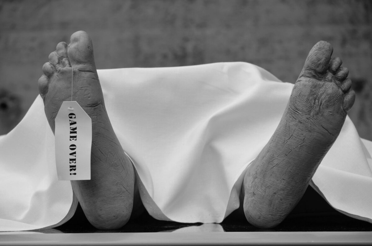 grayscale-photo-of-persons-feet-on-white-textile