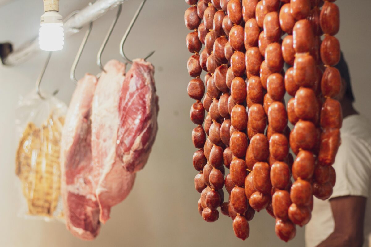 assorted-meats-hanging-in-a-butcher-shop