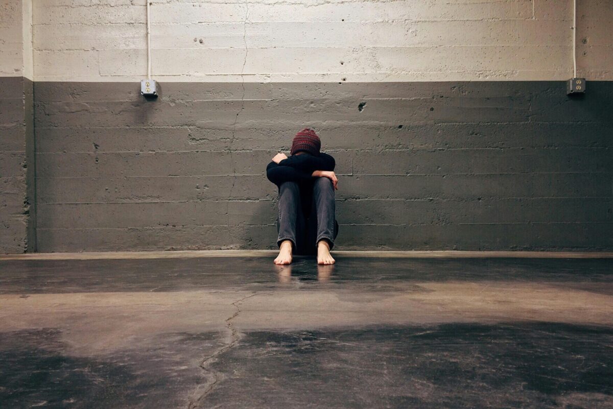 person-leaning-on-wall