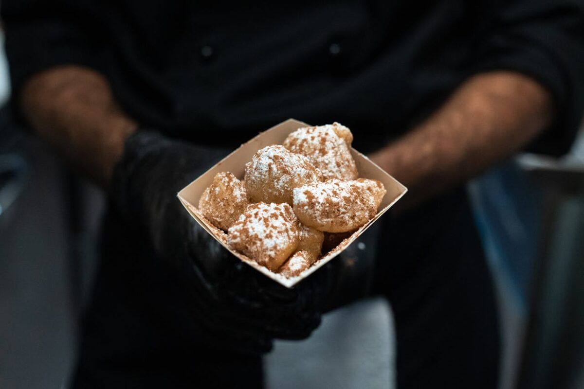 9 Worst Breakfast Foods in Every State 1 person-holding-brown-and-white-pastry-in-a-square-box-