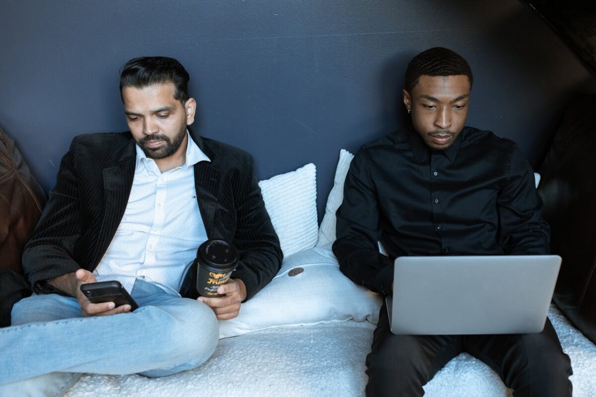 9 Ways Comparison Culture Creates Unhappiness 1 man-in-black-jacket-sitting-on-couch-beside-man-in-black-jacket-