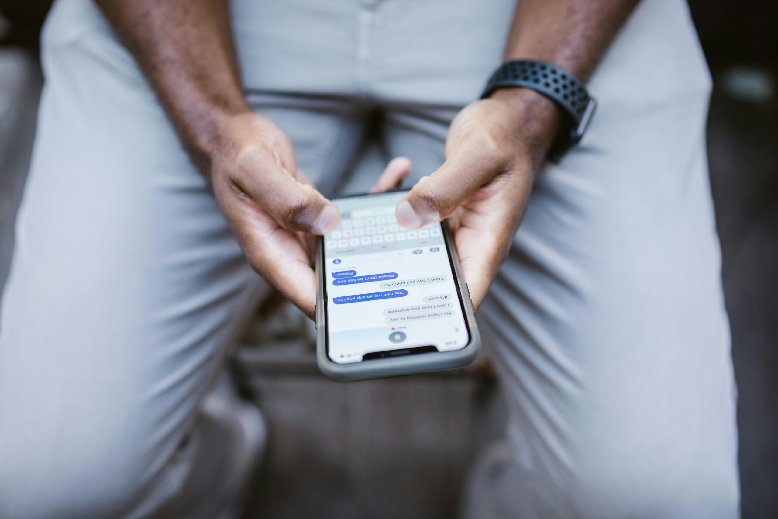 man-s-thumbs-typing-on-a-smartphone