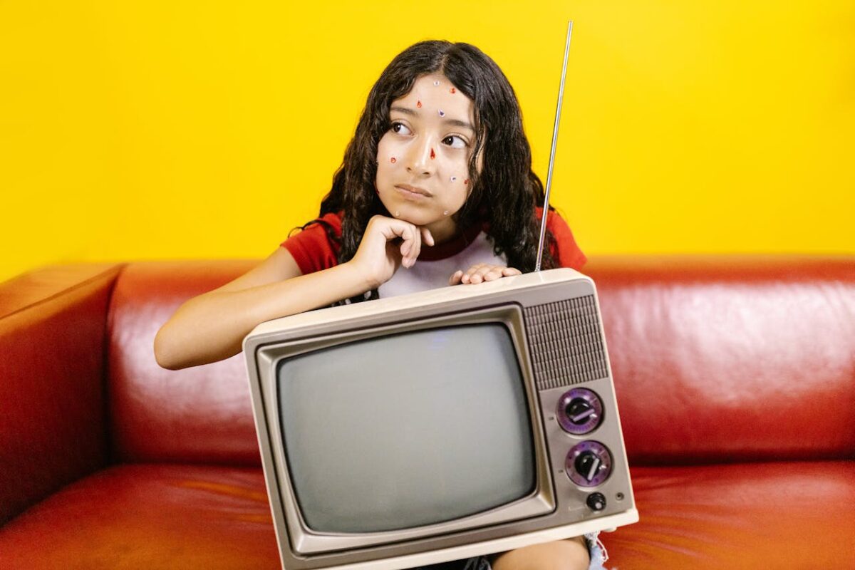 a-woman-with-face-stickers-holding-a-crt-television-