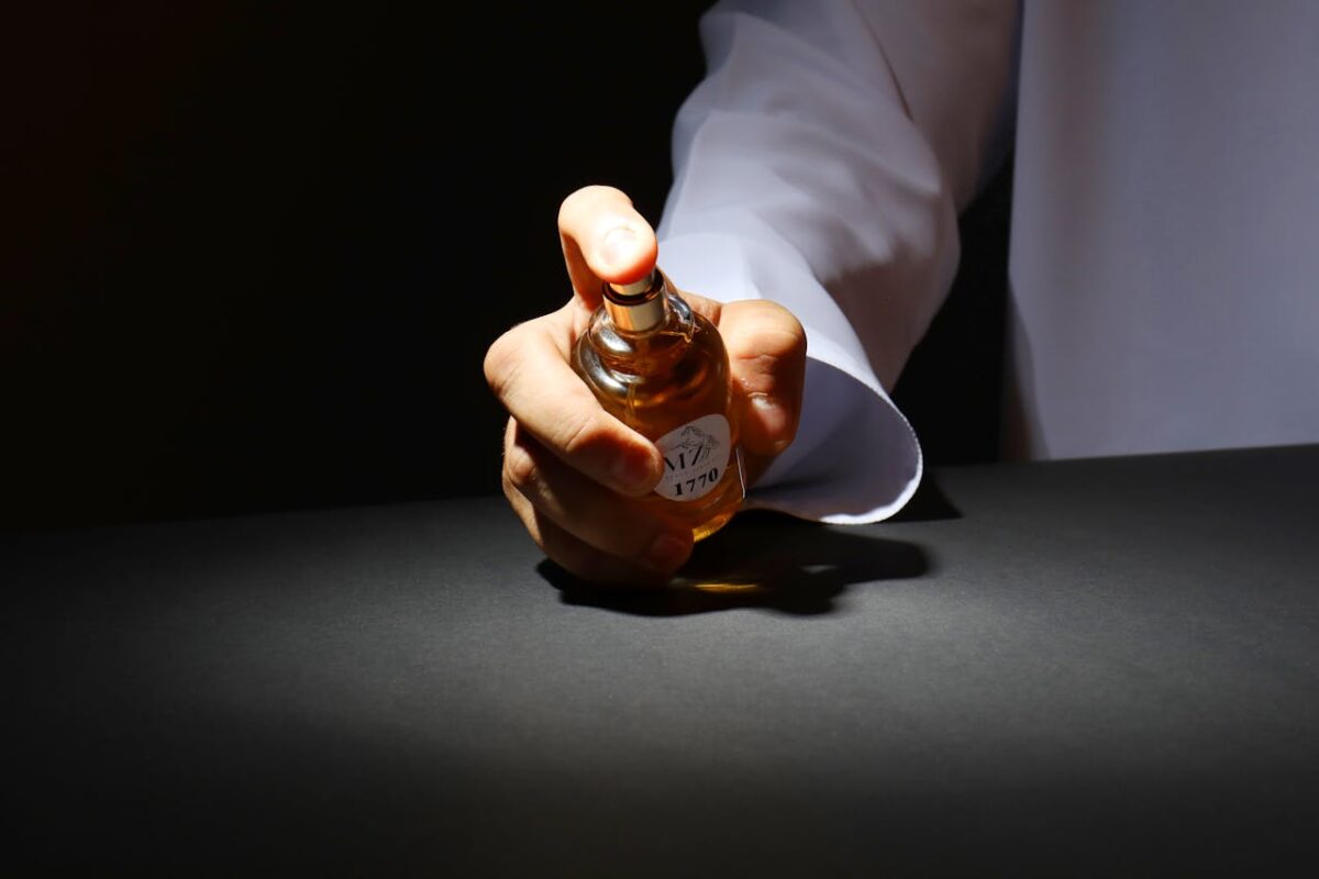 a-person-holding-a-perfume