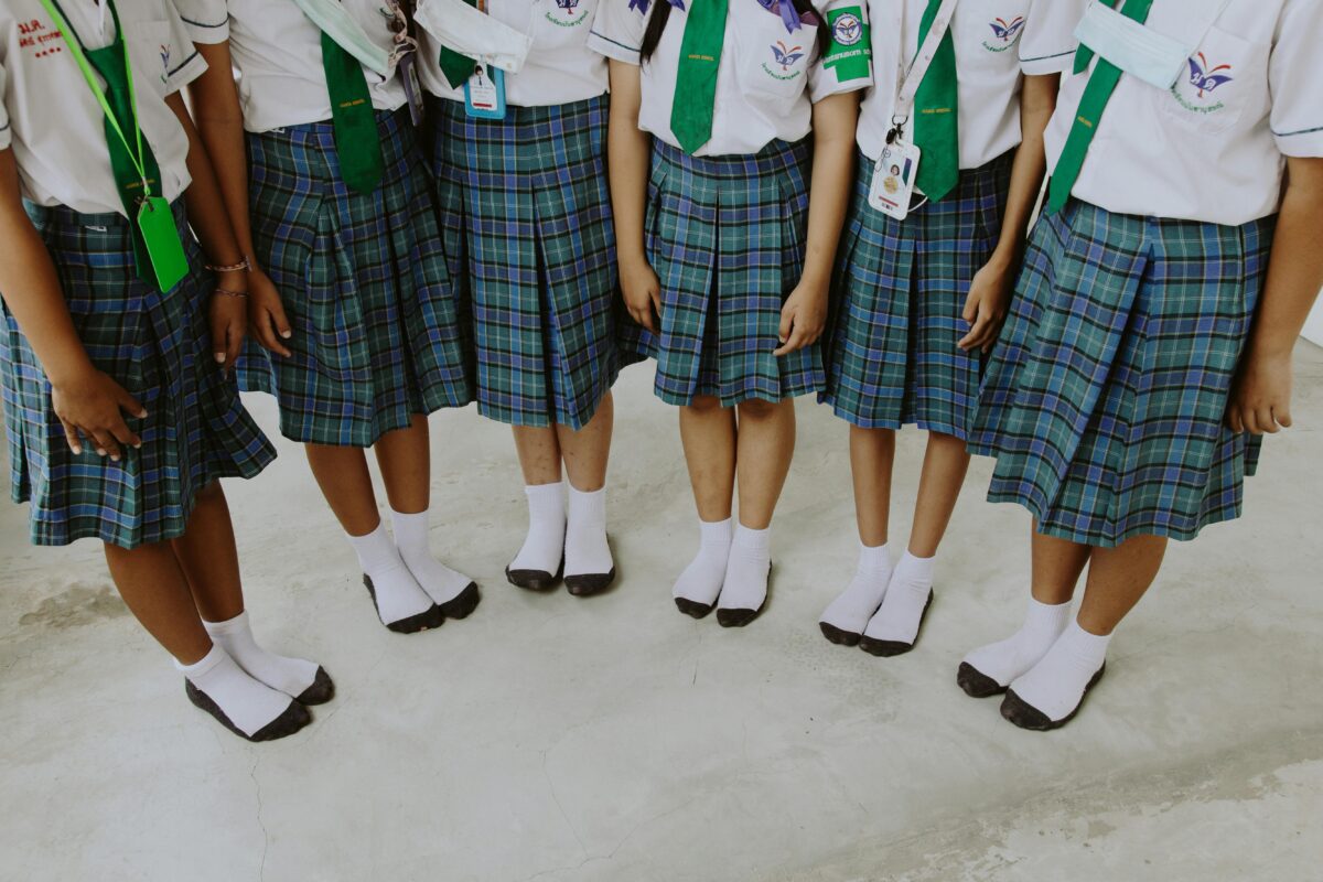 8 Creepy Ways Clothing Helps Cults Control People 1 low-section-of-girls-in-school-uniforms-standing-side-by-side
