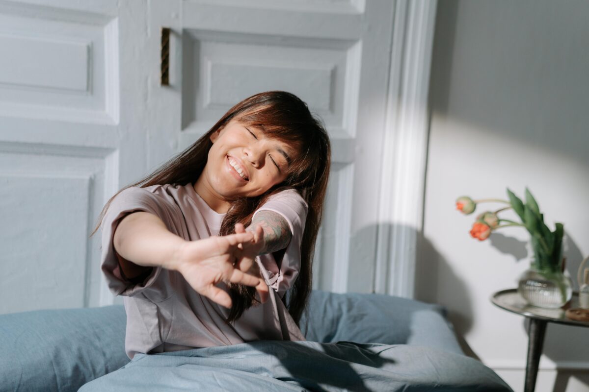 woman-with-dwarfism-stretching-while-waking-up
