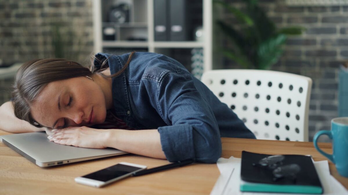 a-woman-sleeping-at-her-office-desk-