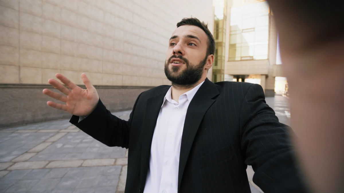 confident-businessman-outdoors-talking-expressively