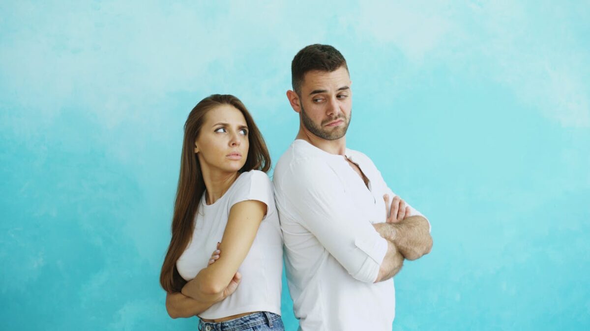 /annoyed-couple-standing-back-to-back-