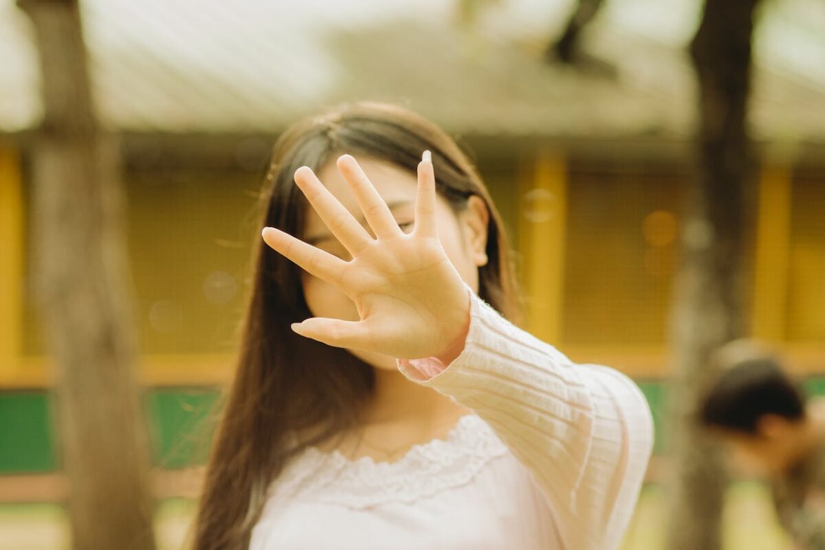 woman-obsuring-face-with-hand-