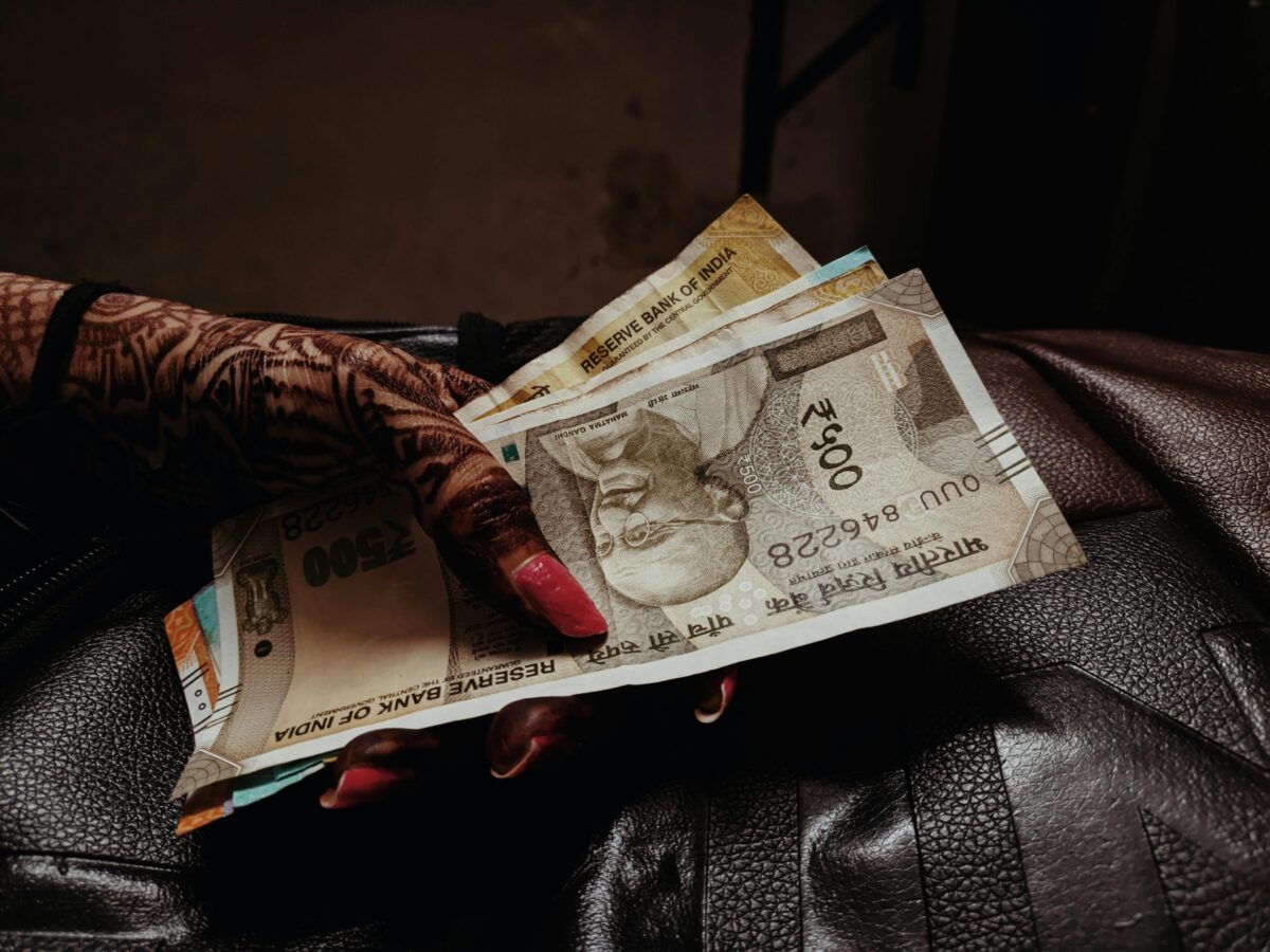 close-up-of-woman-wearing-a-lace-glove-holding-cash