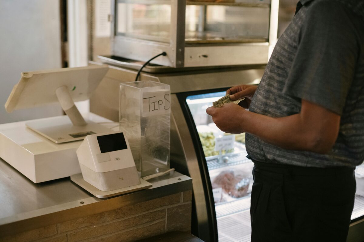 crop-man-standing-near-cash-machine