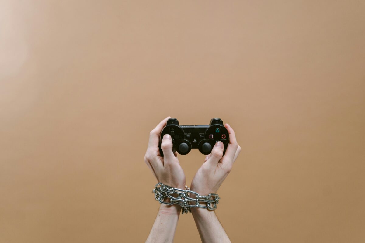 7 Weird Reasons Some People Secretly Enjoy Relationship Drama 3 close-up-shot-of-a-person-holding-a-game-controller