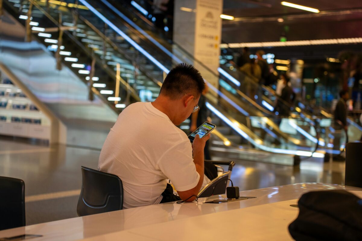 businessman-using-smartphone-at-doha-airport