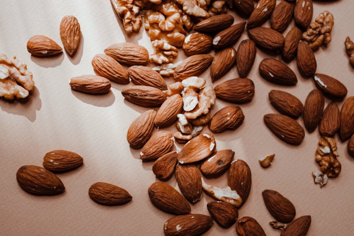 10 Popular Foods That Make Kidney Stones Worse 2 a-brown-almonds-and-walnuts-on-a-flat-surface-