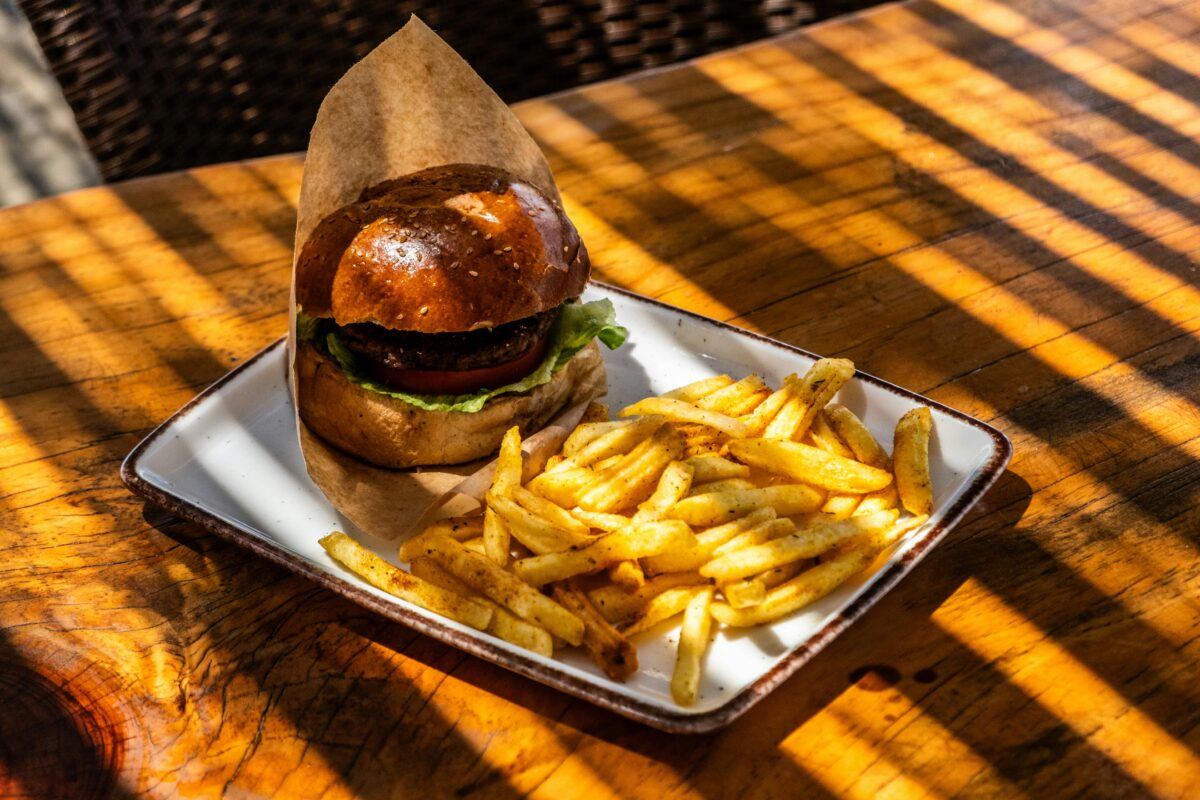 8 Food Myths That Diet Trends Made Worse 1 a-burger-and-fries-on-a-plate-on-a-table
