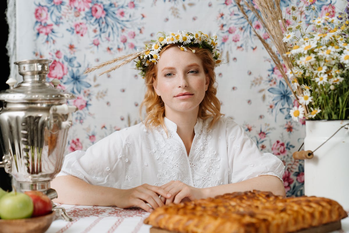 Portrait of a woman with floral wreath, traditional Russian tea setup with samovar.