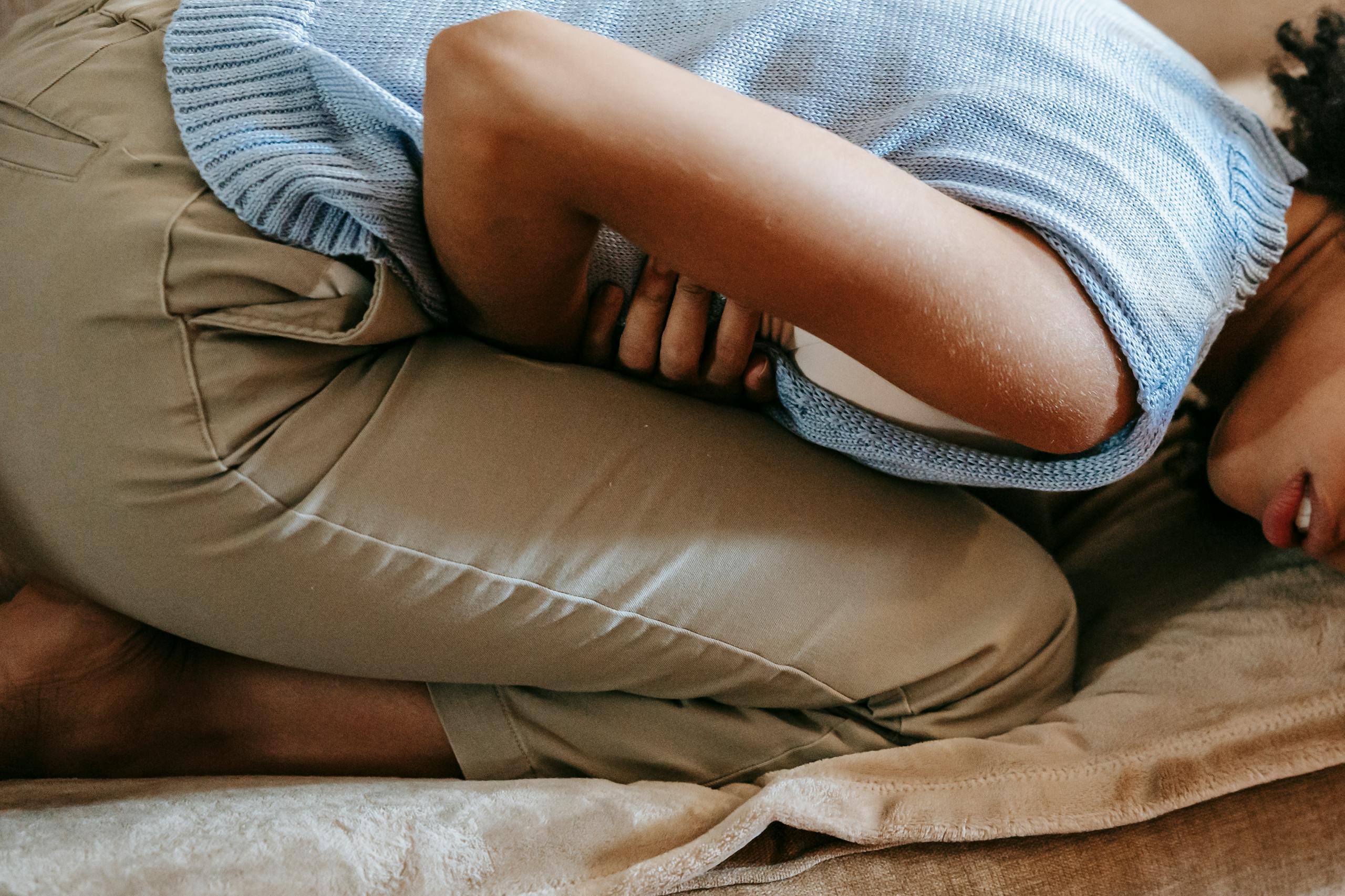 8 Terrifying Ways Your Gut Could Be Controlling Your Whole Body 3 Side view of crop anonymous African American female in agony having acute stomach ache