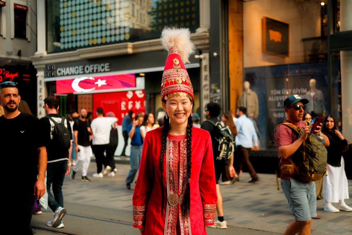 Smiling woman in traditional attire in İstanbul crowds