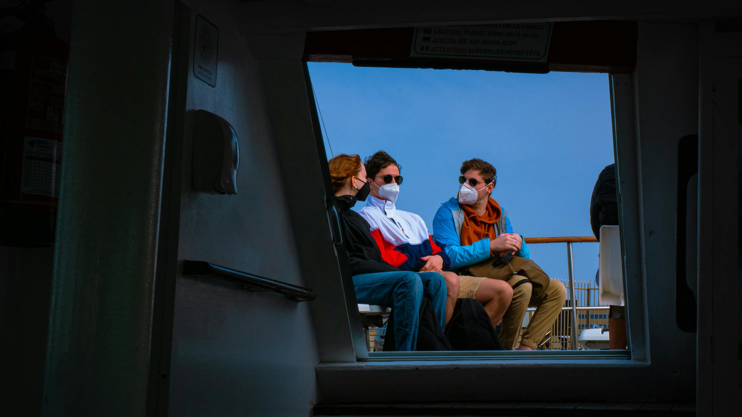7 Chilling Lessons from the Hantavirus Cruise Ship Outbreak That Put Global Travel on Edge 4 Three passengers sit on a ferry in Spain, wearing masks. Travel amid pandemic.