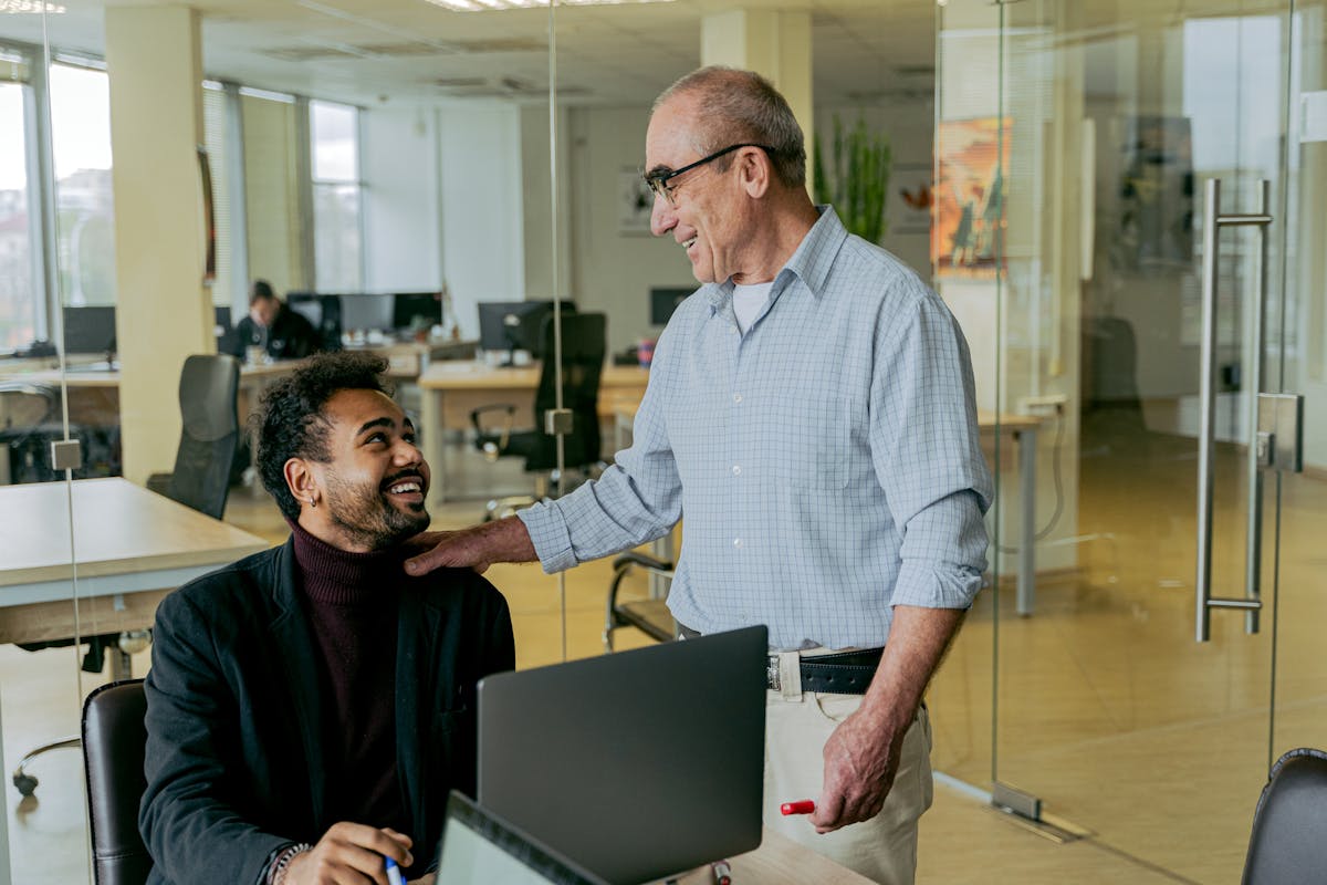 10 Gen X habits bosses believe are career killers 5 Two diverse professionals engage in a friendly conversation in a modern office setting. working