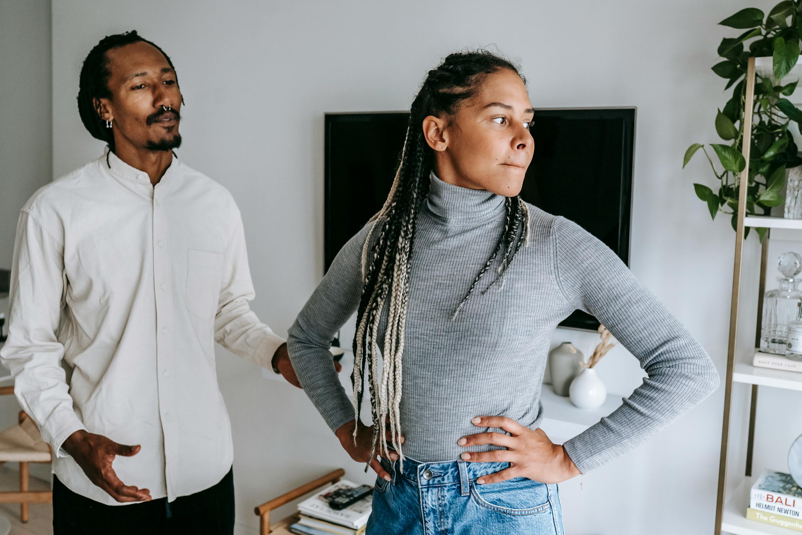 Man Moved to NYC for Love, Then His Girlfriend Still Wouldn’t Move In 1 Unhappy African American couple quarreling while spending time together in light modern apartment