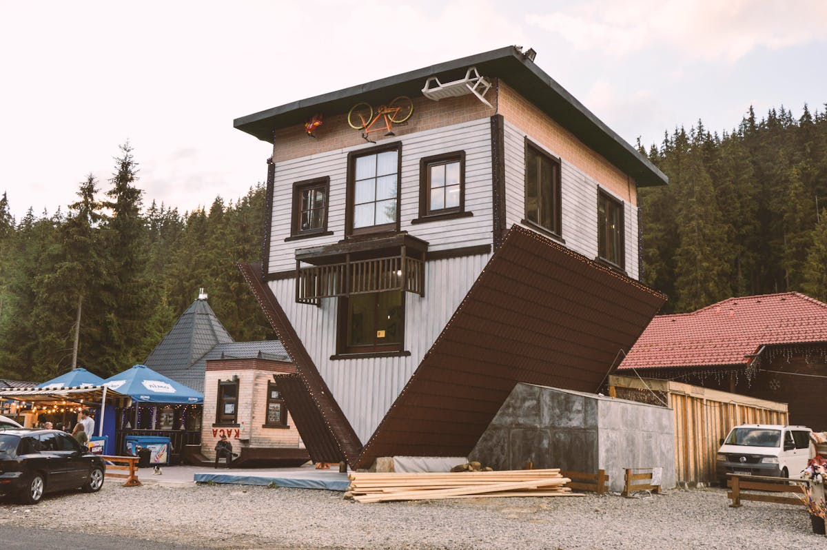 5 Reasons Rent is Quietly Destroying the Financial Future of Americans 2 Unique upside down house exterior showcasing architectural oddity in Poland.