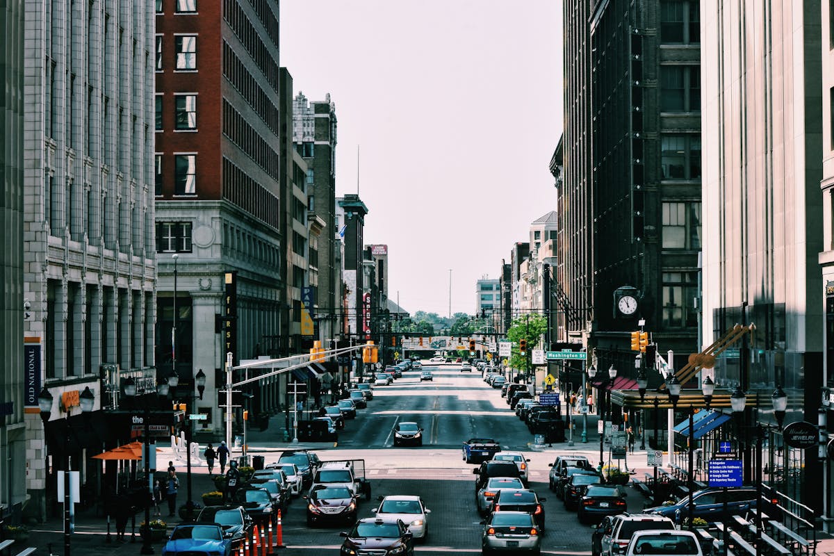 Vibrant city street with heavy traffic and towering buildings in daylight