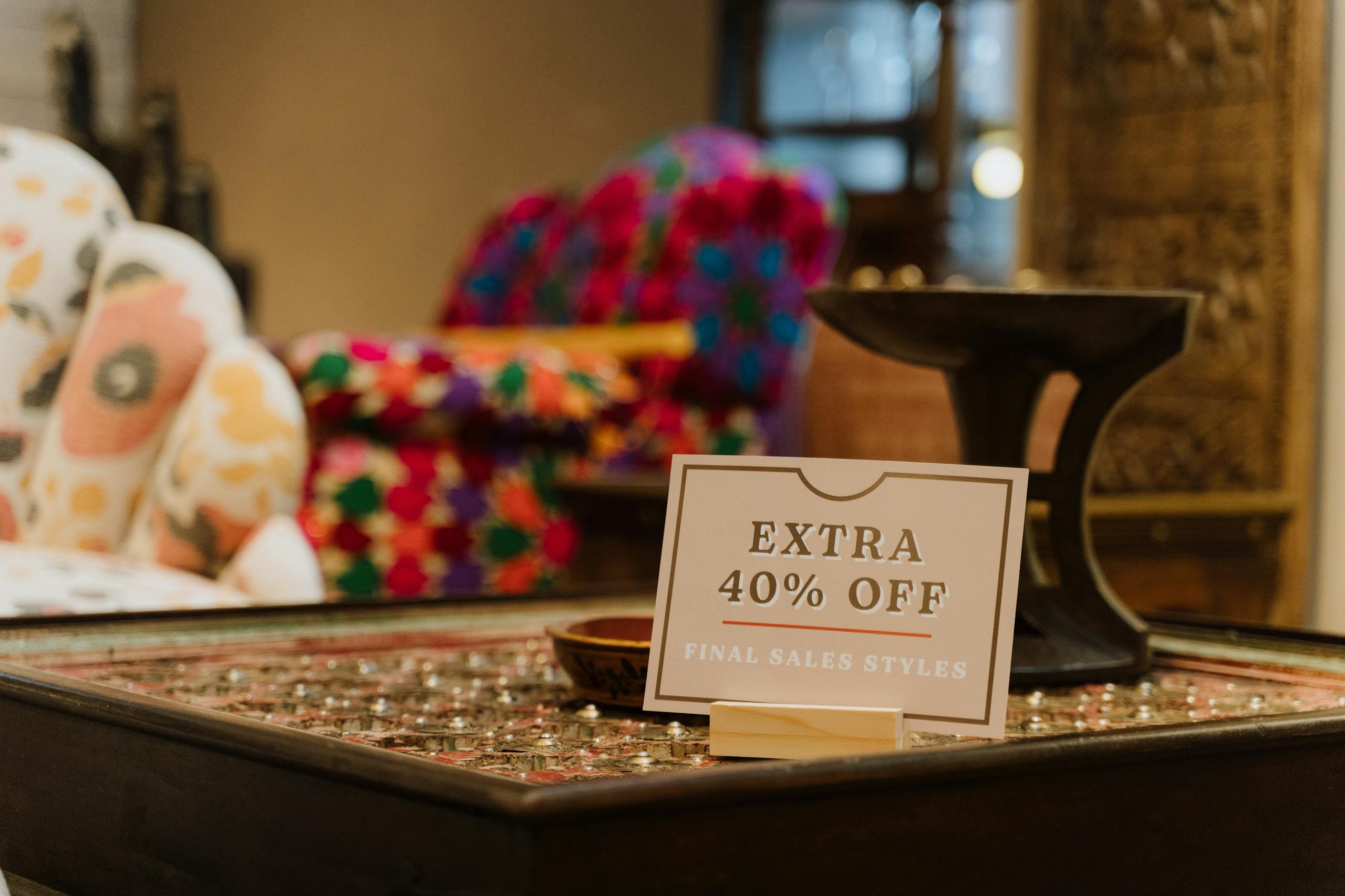 12 Sneaky Tricks Companies Use to Drain Your Wallet 4 Warm store interior showcasing a discount sign offering extra 40% off on final sale styles.