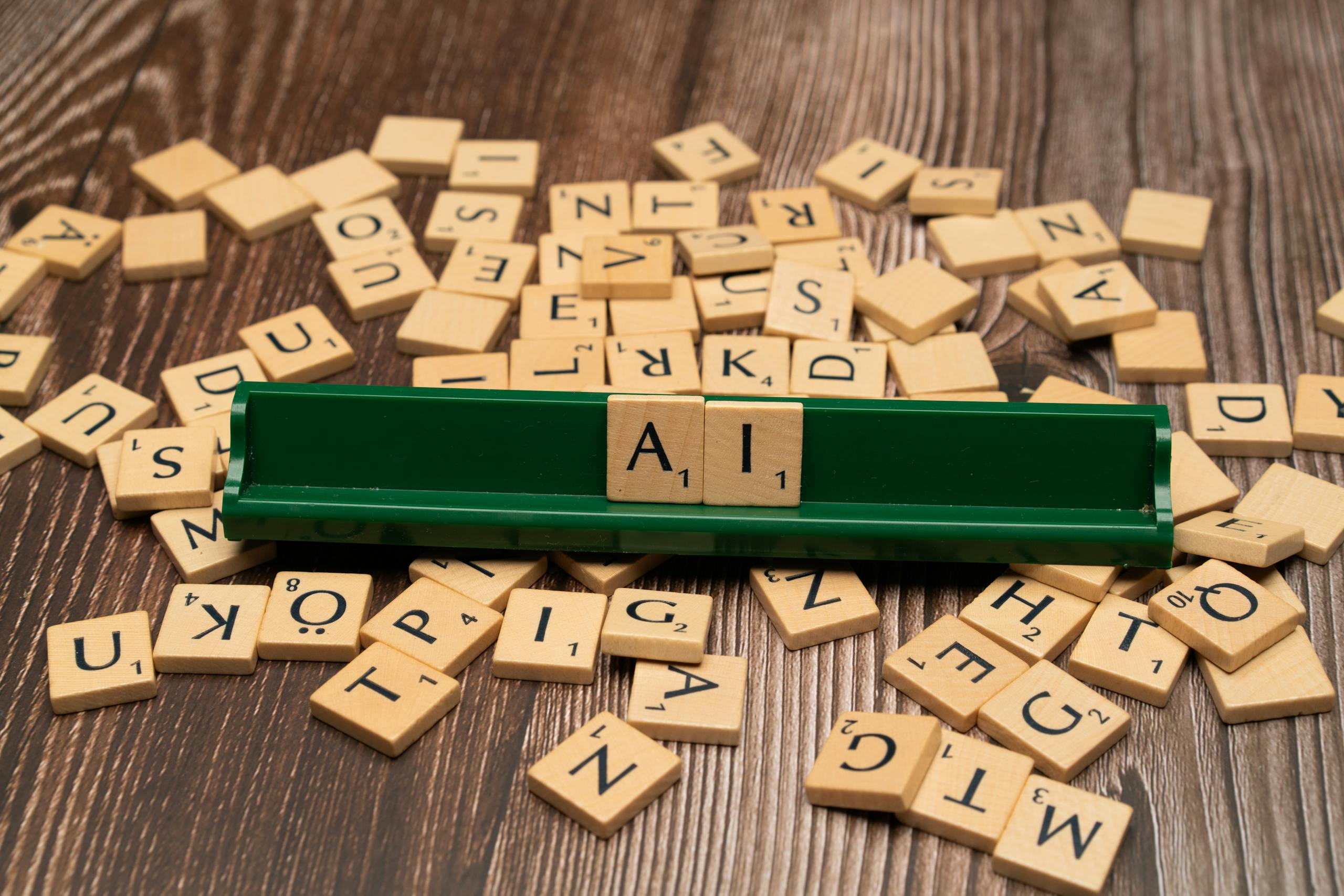8 Creepy Ways AI Images Are Changing How People See Themselves Online 1 Wooden letter tiles spelling AI, representing technology and innovation.