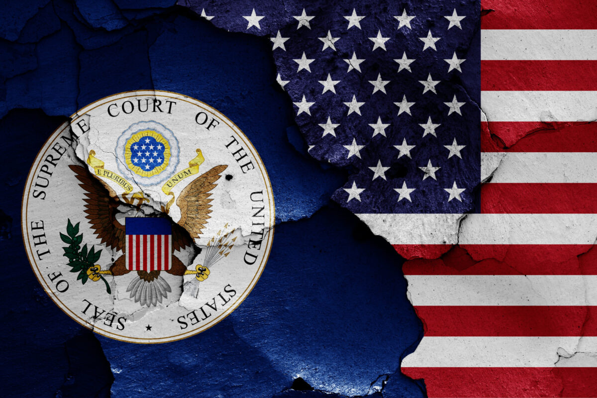 flags of Supreme Court of the United States and USA painted on cracked wall