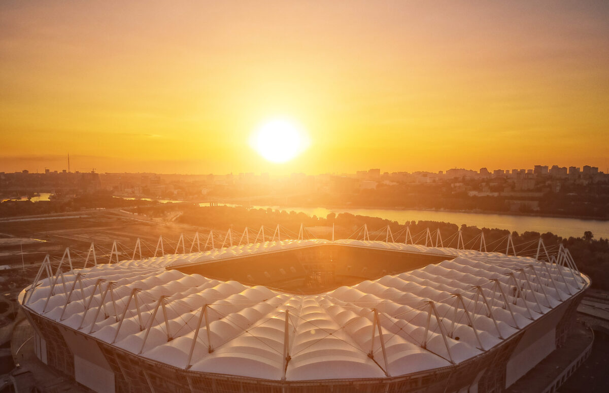 construction of the stadium. aerial view. roof of the stadium on the city's background. sunset.