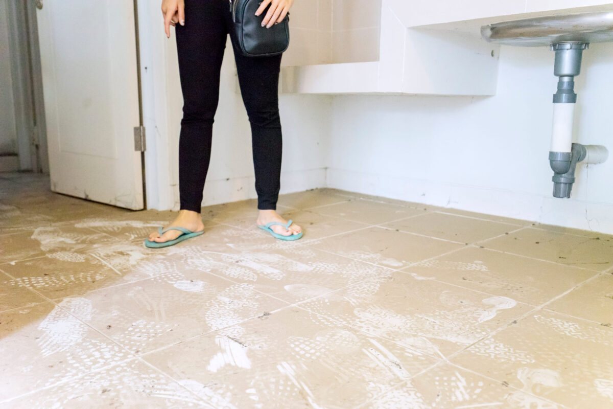 10 Gross Habits Some Men Ignore Like Nobody Notices 2 Woman stands on dirty floor of an empty house