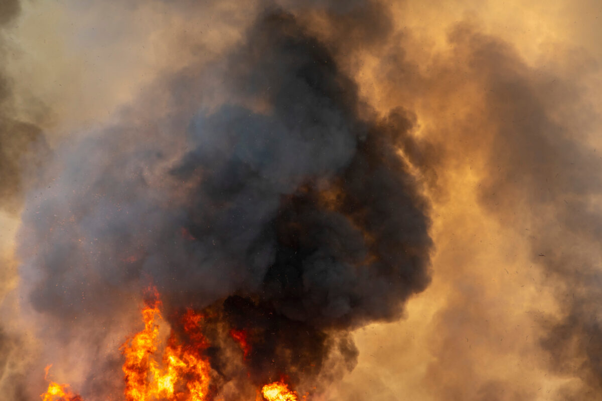raging dust smoke pattern background of fire burn in grass fields, forests and black and white smoke to sky. Big wildfire close-up. pollution in air concept. wildfire make to smoke bush pollution in world.