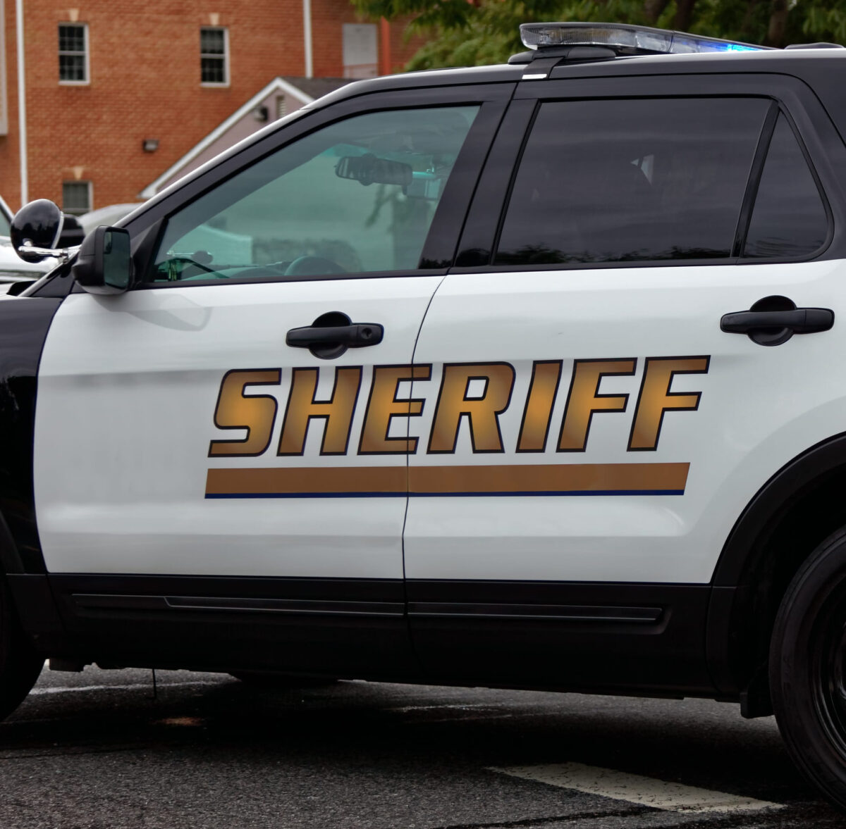 Deputy Stabbed, Man Killed After Violent Encounter at Lancaster Metrolink Station 2 Side view of Sheriff`s car door with SHERIFF text symbol.