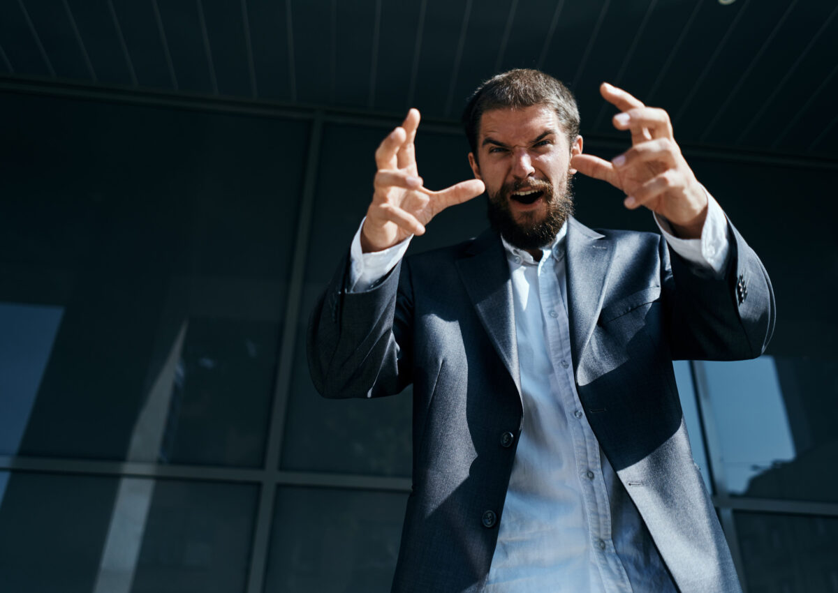 Business man in suit outdoors near building emotions fun