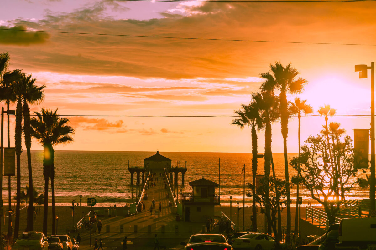 10 U.S. States With the Worst Air Quality Problems 1 Manhattan Beach USA - October 6 2015; Pier and lifeguard station at sunset whild people in silhouette enjoy last of setting sun in California