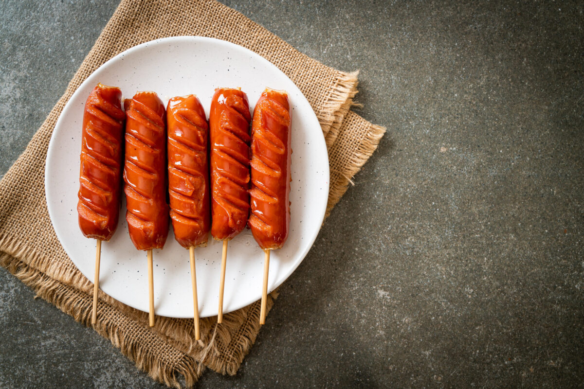 fried sausage skewer on white plate