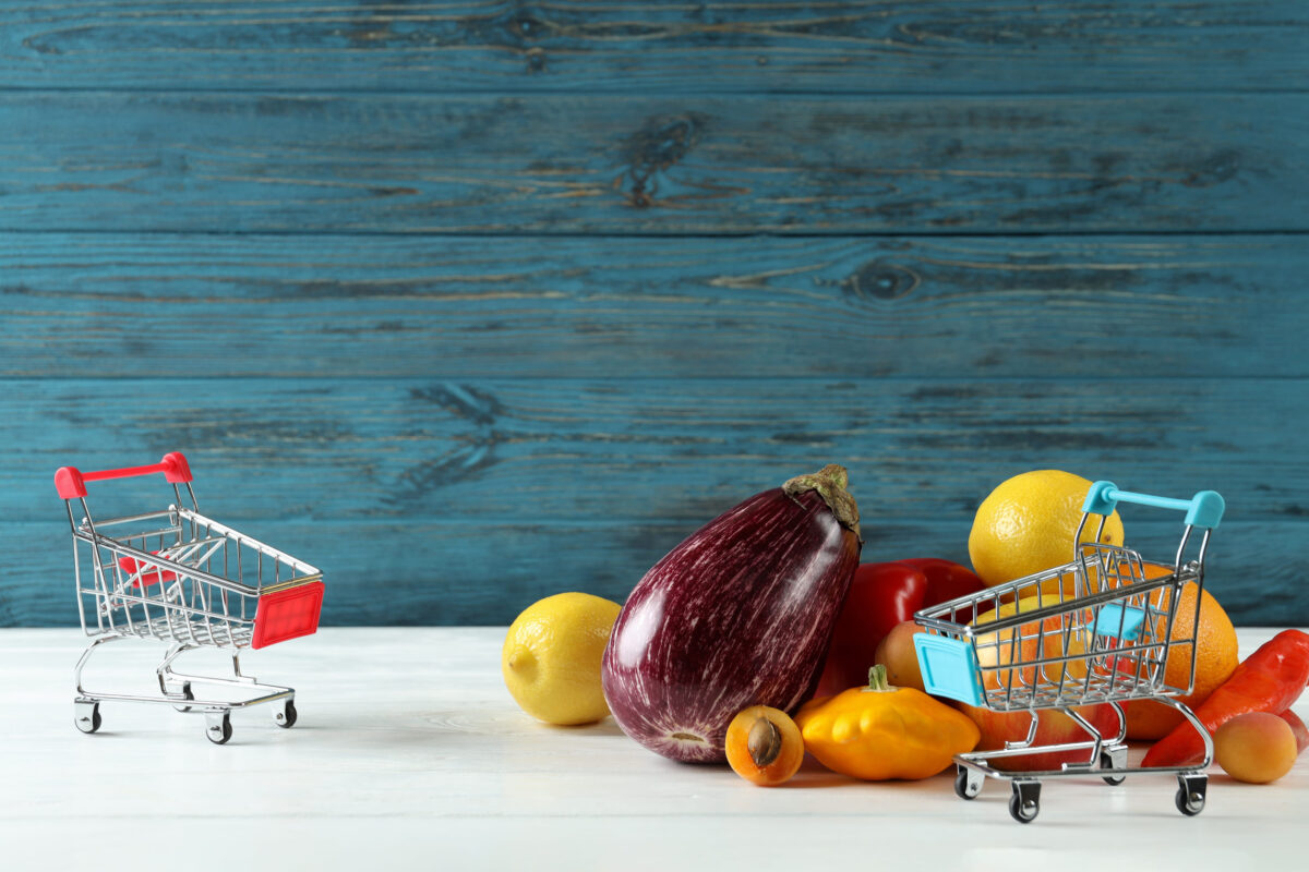Shop carts, vegetables and fruits on wooden table