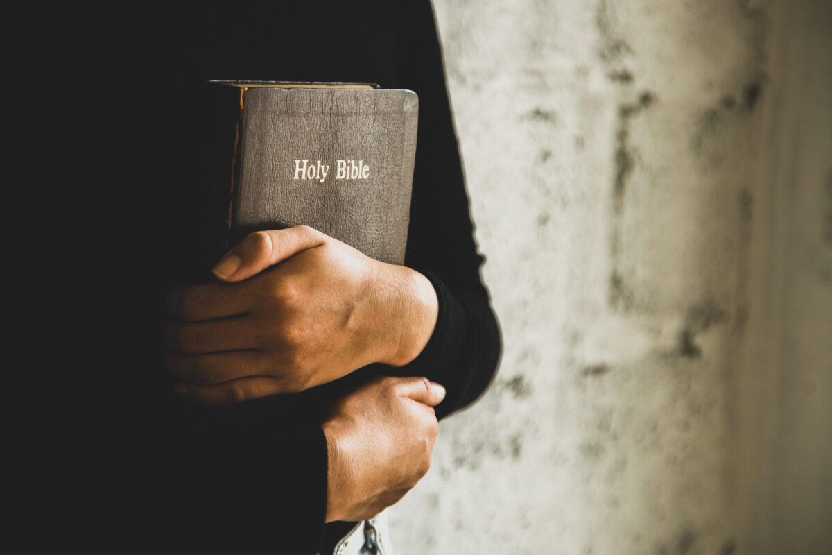 Texas Bible Curriculum Vote Turns Classrooms Into the Latest Culture-War Battleground 3 Women reading the old heavy book on white background.