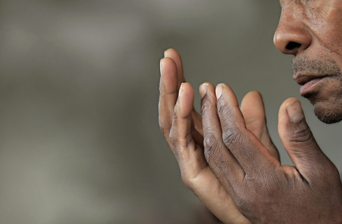 7 Ways to Break Free from the Pressure to Be a Perfect Christian 1 man praying to god with hands together stock photo