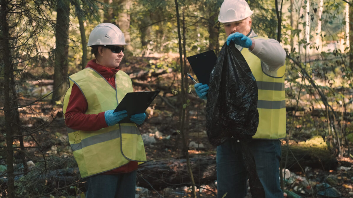 The Woodlands May Face Higher Water Bills as Aging Infrastructure Demands Attention 4 Man and woman environmentalists in workwear and helmets document offense - forest pollution and issue fine. Concept of pollution of natural parks, woods and nature reserves with non decomposable waste