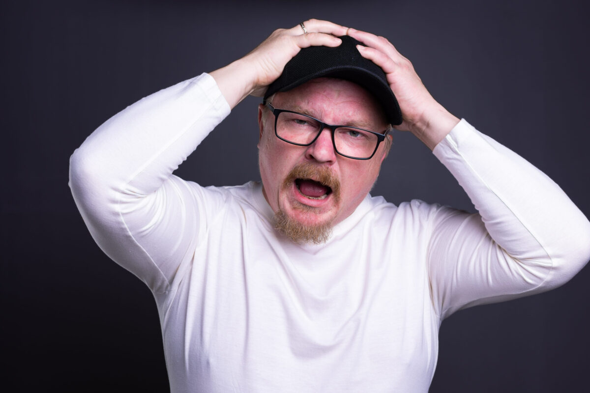 Portrait of an emotional man with glasses on a gray background surprise I remembered something forgot